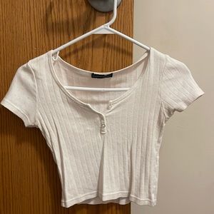 Pink Brandy Melville Tshirt with buttons down the middle, in perfect condition.